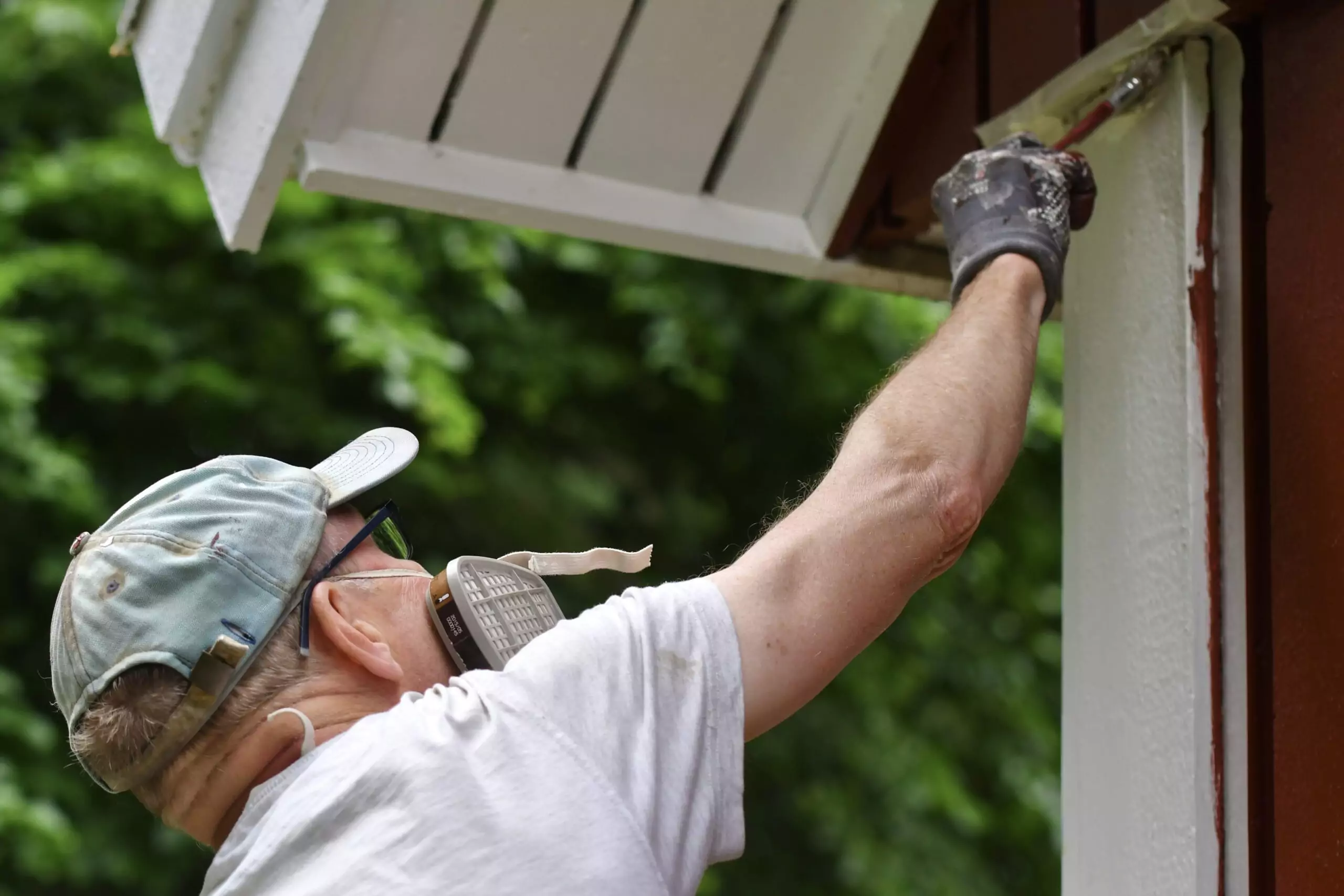 a-man-painting-house-exterior-with-white-color-prime-one-builders