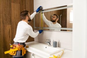 the-worker-installs-the-mirror-in-the-bathroom-10-18-17-10-38-prime-one-builders